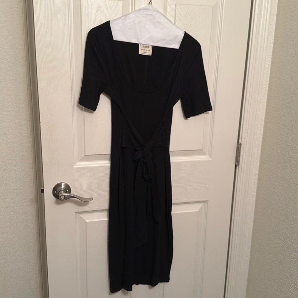 Black ribbed midi dress with scoop neck and front tie.